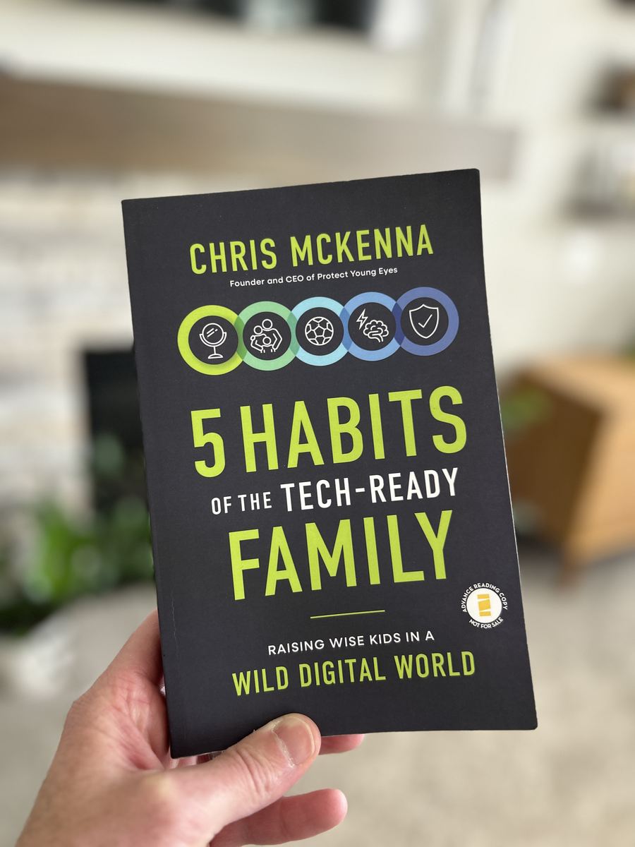 Chris McKenna holding his book, 5 Habits of the Tech-Ready Family